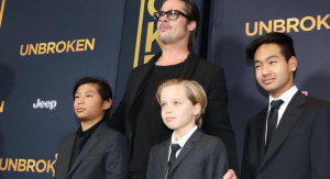 John, center, with dad and brothers at the 'Unbroken' premiere. (Photo: Matt Sayles, Invision/AP)